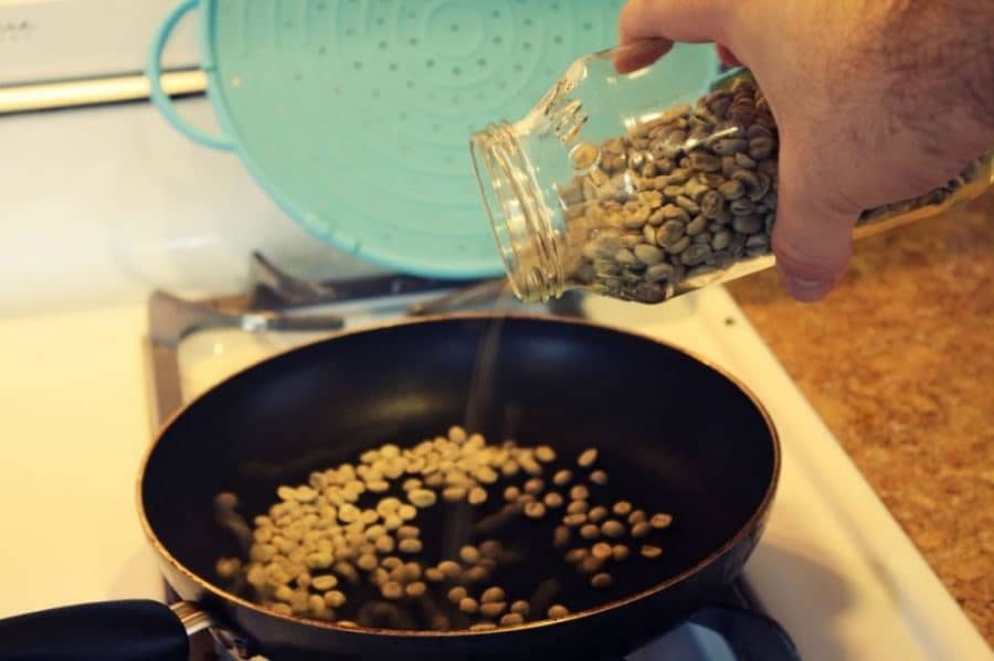 Pour in green coffee beans to roast them