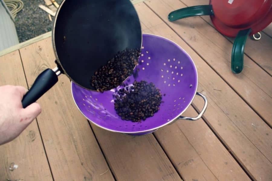 Cool roasted coffee beans in a cooled colander