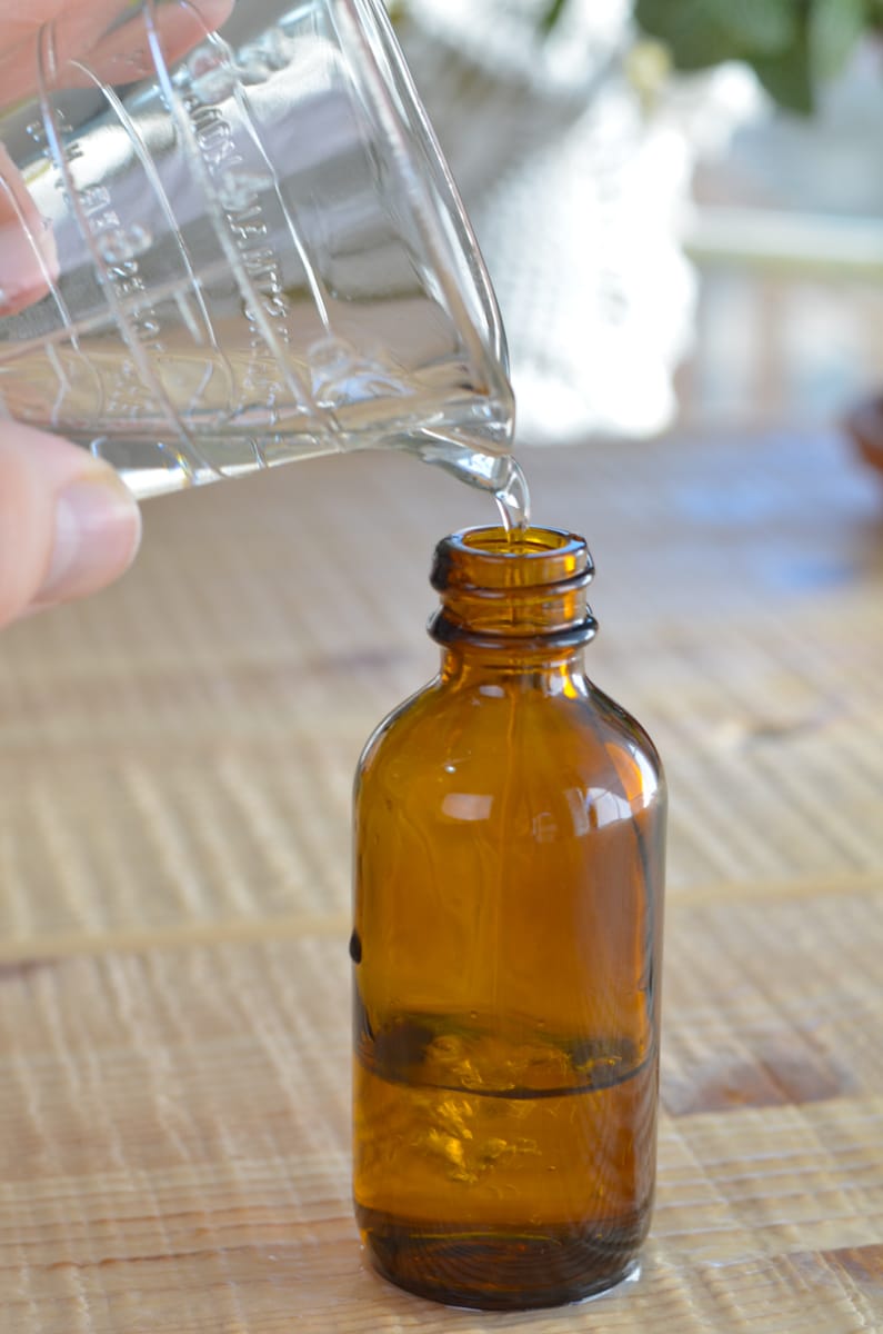 pour vodka into brown glass bottle